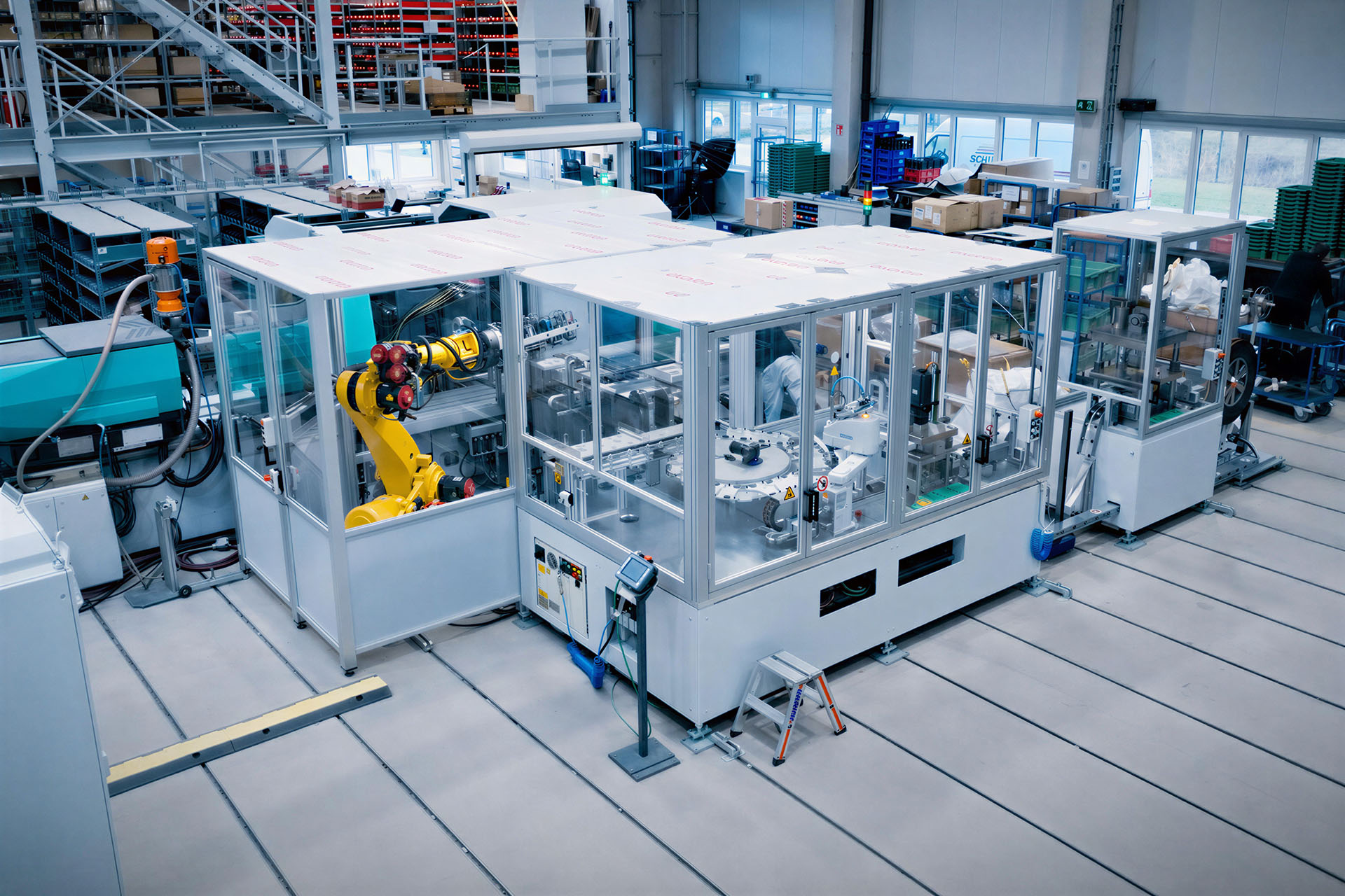 Automated special-purpose machine with robotic cell in a production hall.