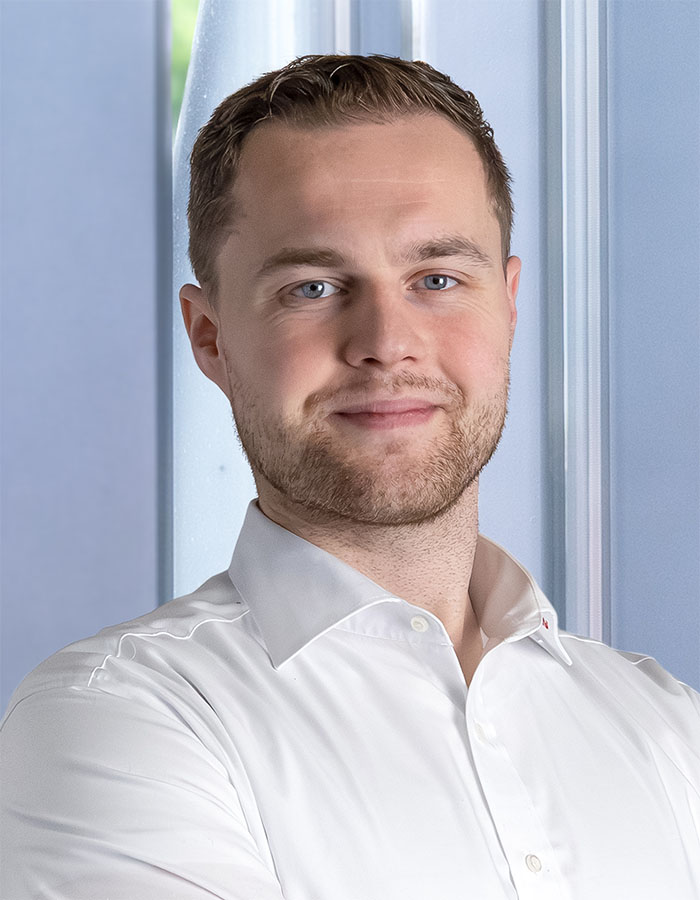 Tobias Möller, Head of Special Machine Construction, looks at the camera.